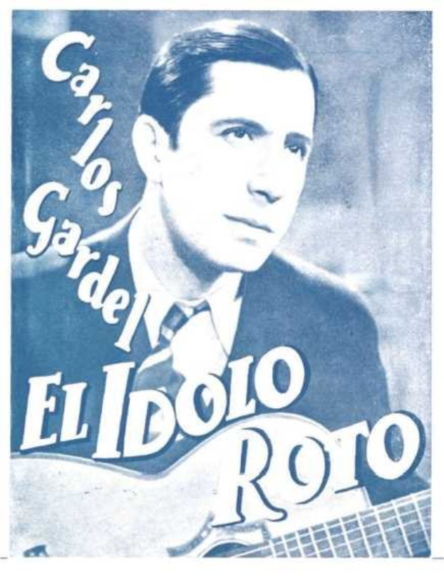 Ein Plakat von El Idolo Roro, einem spanischen S├Ąnger-Schreiber, der eine Gitarre h├Ąlt und einen ernsten Ausdruck hat, ein weißes Hemd und einen schwarzen Anzug tr├Ągt, vor einem hellblauen Hintergrund mit fetter schwarzer Schrift.