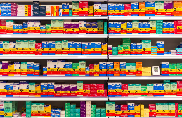 Ein Apothekenschrank voller verschiedener Medikamentenschachteln und Behälter, die ordentlich angeordnet sind.