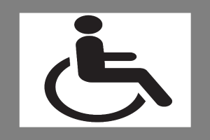 Ein schwarzes und weißes Schild mit einer Person im Rollstuhl vor einem grauen Hintergrund, das die Barrierefreiheit für Menschen mit Behinderungen symbolisiert.